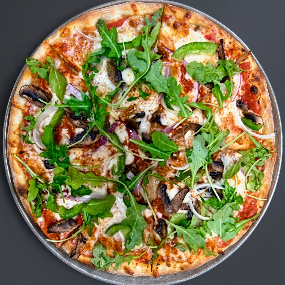 Round thin-crust pizza topped with melted cheese, mushrooms, green peppers, red onions, black olives, and fresh arugula.