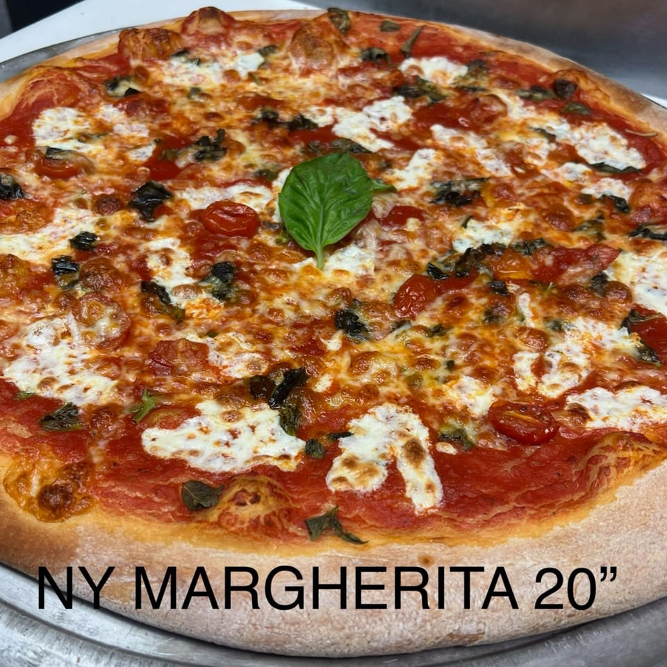 A large, round Angolino Pizza Margherita with melted cheese, tomato sauce, and fresh basil.